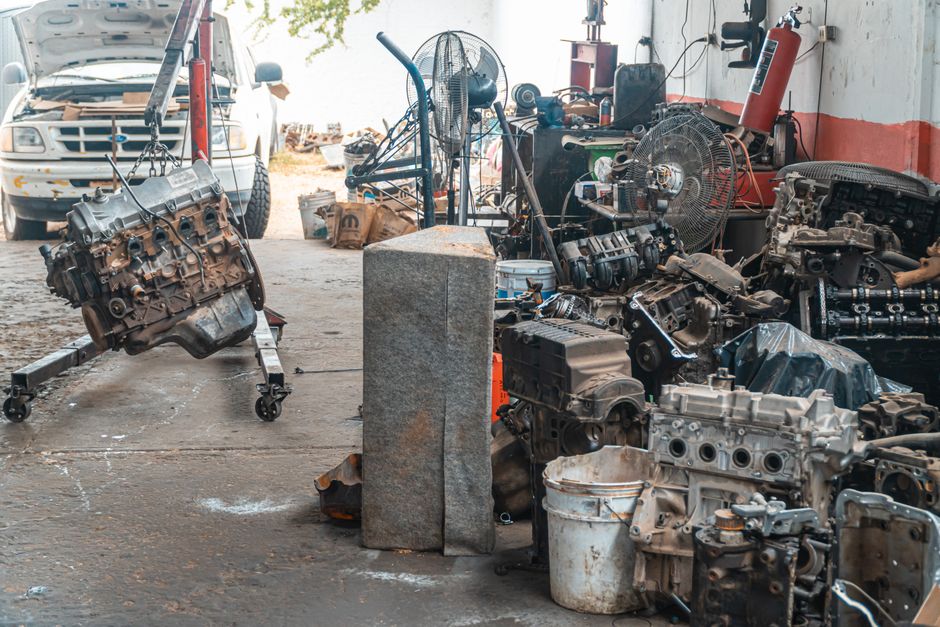 Auto workshop displaying a collection of engine parts and repair equipment.
